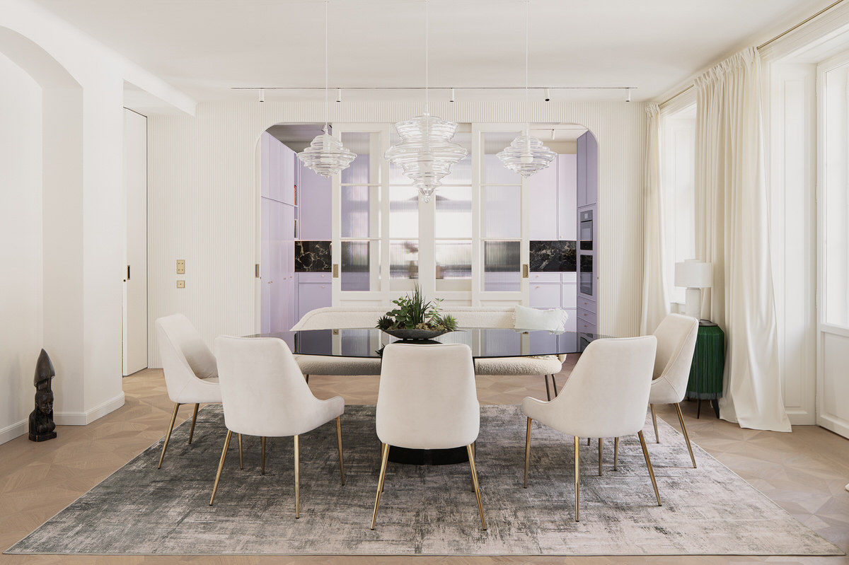 Hell gestaltetes Esszimmer mit ovalem Esstisch. Dahinter befindet sich die Küche, welche durch ihre lila Farbe deutlich hervorsticht.
